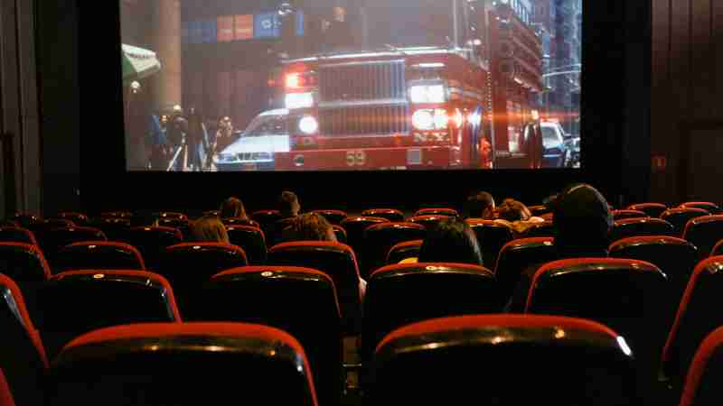 People seated in a cinema watching a movie on a large screen., tags: deutschlands - pexel